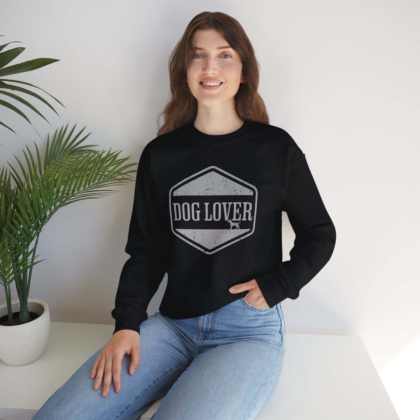 Dog Lover Vintage Badge Unisex Crewneck Sweatshirt worn by a smiling woman in a cozy setting.