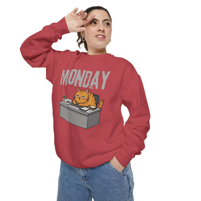 Monday Face Cat Stares Blankly Unisex Crewneck Sweatshirt in red with humorous cat design and 'MONDAY' text.