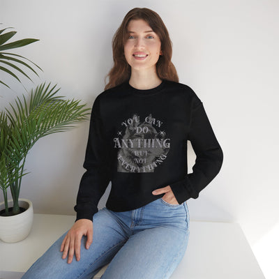 Model wearing a cool dog graphic sweatshirt with the quote 'You can do anything but not everything'.