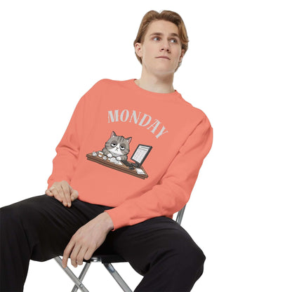 Monday Face Cat Stares Blankly Unisex Crewneck Sweatshirt in coral, featuring a grumpy cat with 'MONDAY' text.