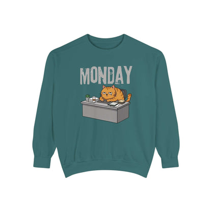Monday Face Cat Stares Blankly Unisex Crewneck Sweatshirt featuring a grumpy cat at a desk with a 'MONDAY' banner.