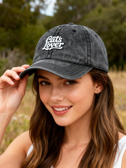 Cats Lover Vintage Embroidered Cap Dad Hat Grey Words model wearing cap outdoors with greenery in background.