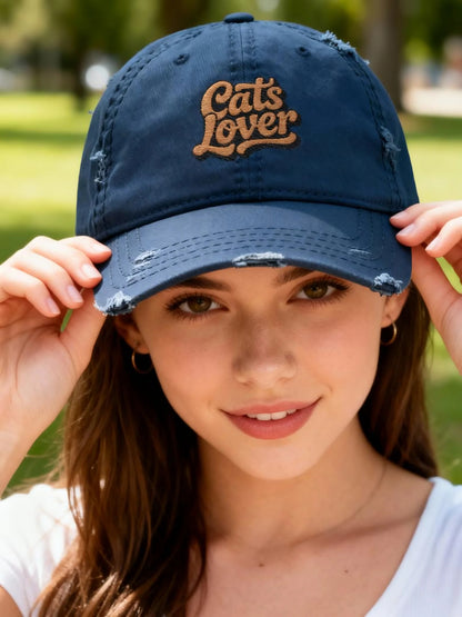Cats Lover Distressed Embroidered Cap Dad Hat Brown Words worn by a model outdoors, showcasing its faded style and embroidered lettering.