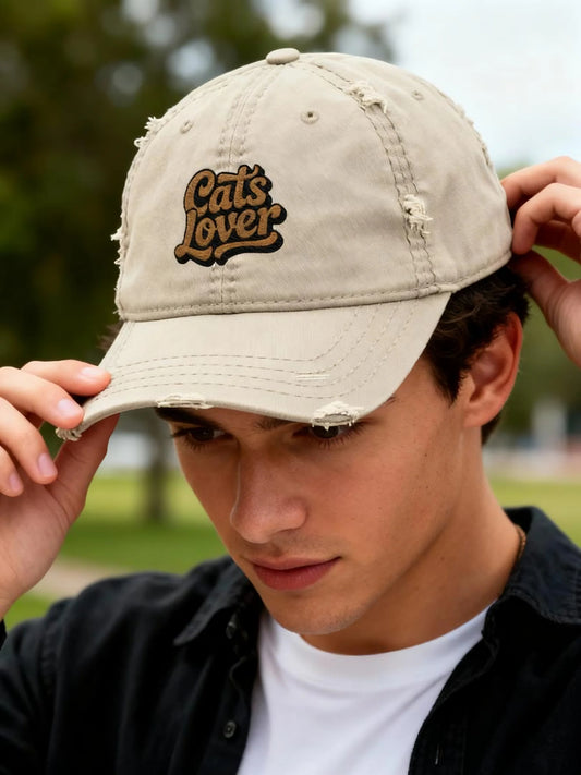Cats Lover Distressed Embroidered Cap Dad Hat Brown Words being worn by a young man outdoors.