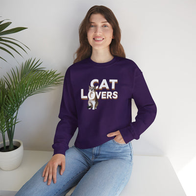 cat lovers cute kitten sweatshirt featuring a woman wearing it with a smiling expression and a plant in the background.