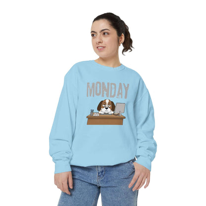Monday Face Dog Stares Blankly Unisex Crewneck Sweatshirt in light blue featuring a dog at a desk under a 'MONDAY' banner.