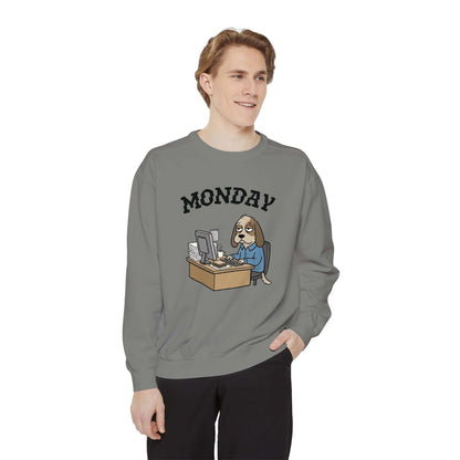 Monday Face Dog Stares Blankly Unisex Crewneck Sweatshirt worn by a man, featuring a dog at a desk under a 'MONDAY' banner.
