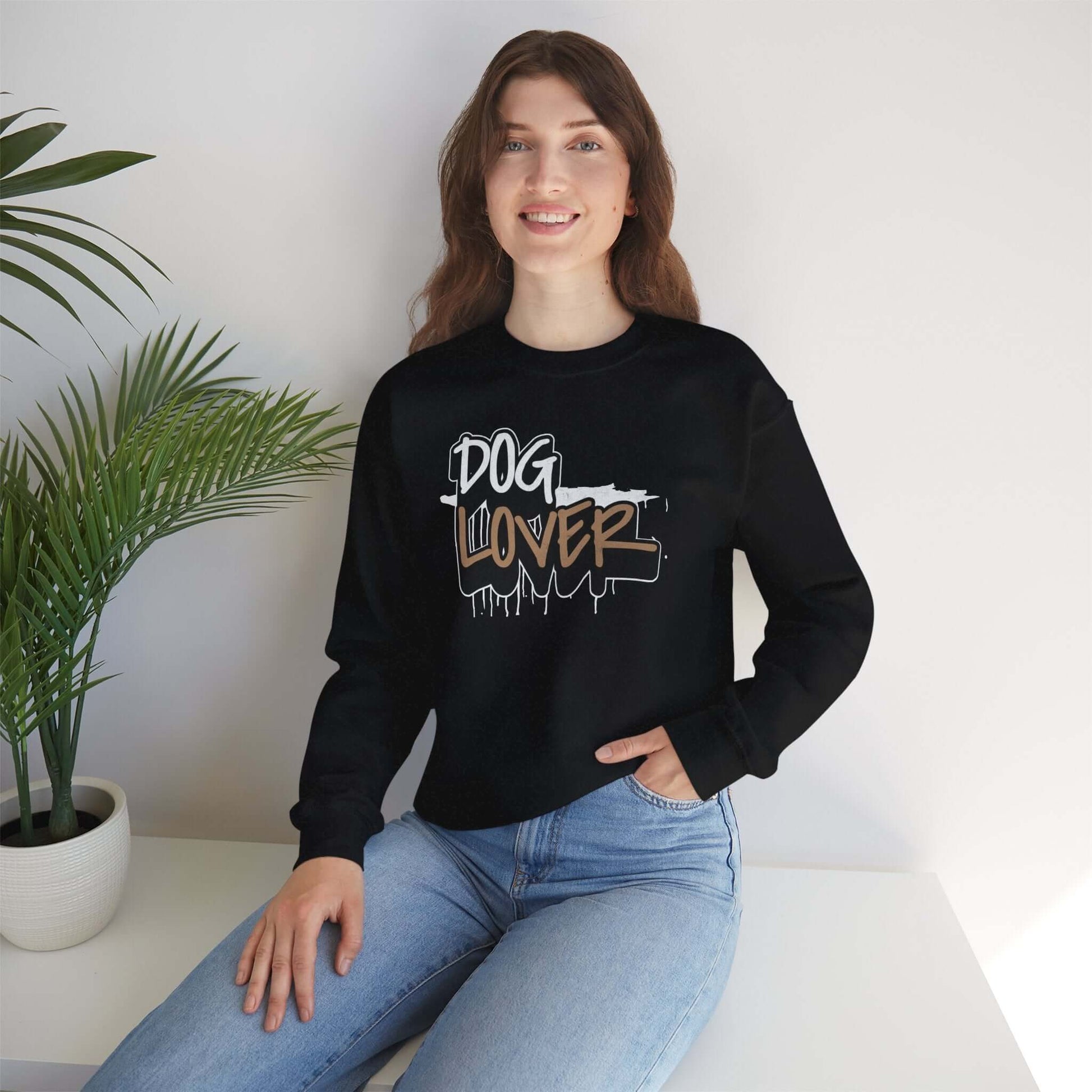 Dog Lover Stylish Unisex Crewneck Sweatshirt worn by a woman in a stylish setting with a plant.